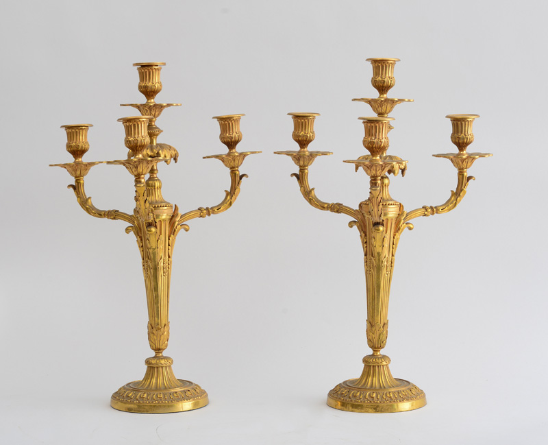 Appraisal: PAIR OF LOUIS XVI STYLE GILT-BRONZE FOUR-LIGHT CANDELABRA Each tapered