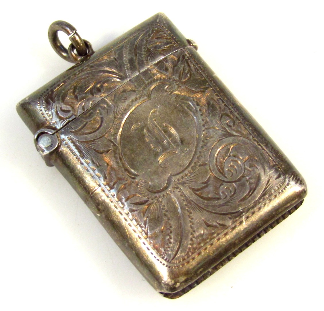 Appraisal: An Edwardian silver vesta case of shaped outline partially engine