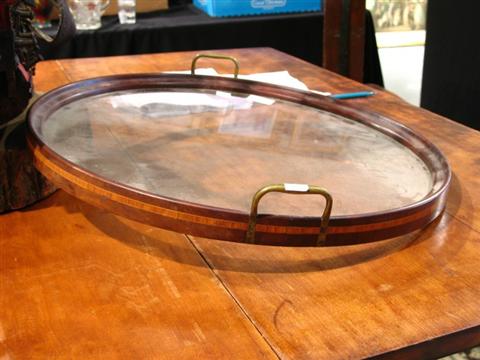 Appraisal: CIRCULAR MAHOGHANY GLASS-BOTTOM TRAY Of simple form with crossbanded stripe