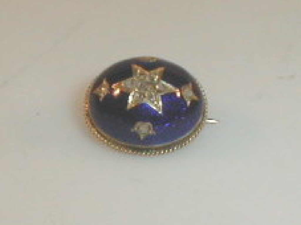 Appraisal: A blue enameled gold brooch inset with diamond chips to