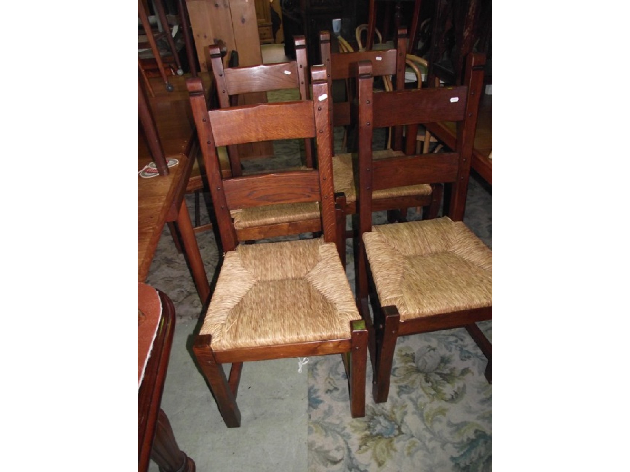 Appraisal: A set of four oak ladder back dining chairs with