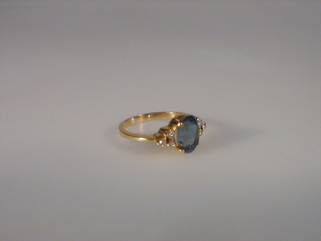 Appraisal: An oval dress ring set with a pale blue oval