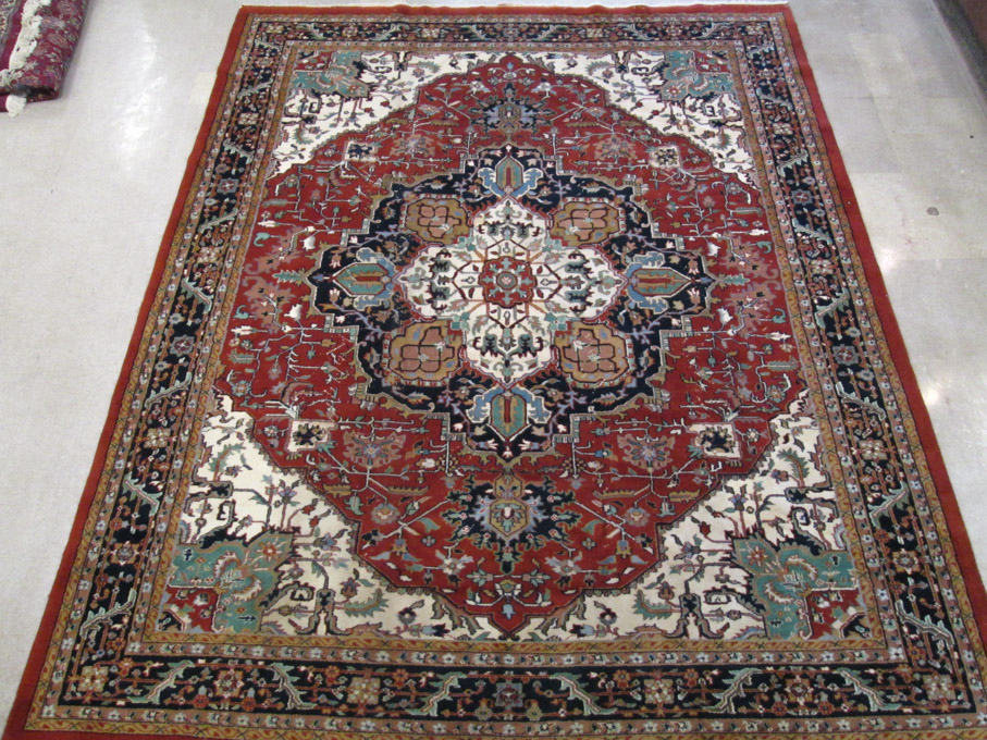 Appraisal: HAND KNOTTED ORIENTAL CARPET Indo-Heriz central medallion and stylized floral