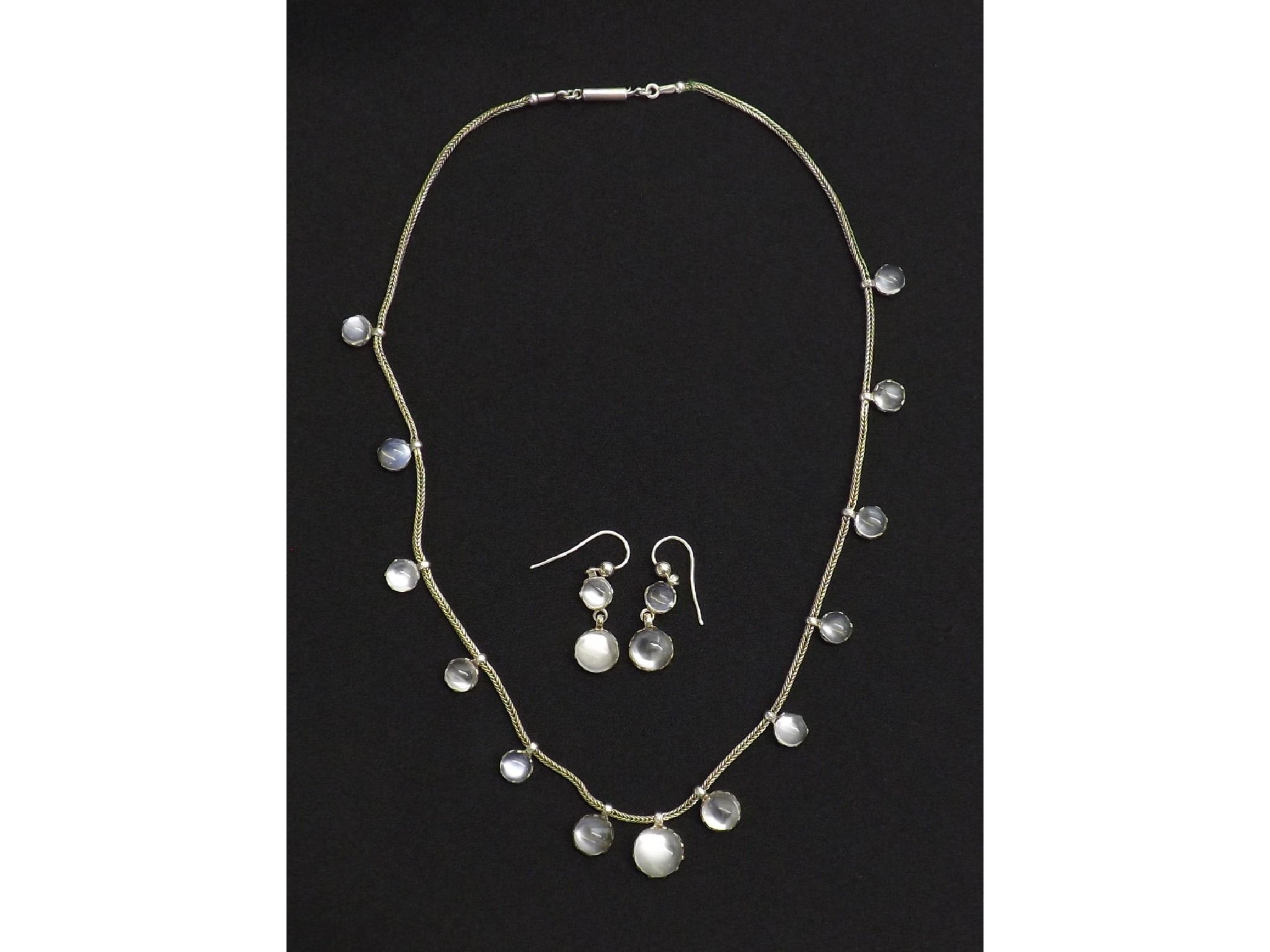 Appraisal: Silver moonstone necklet and matching earrings the necklet with thirteen