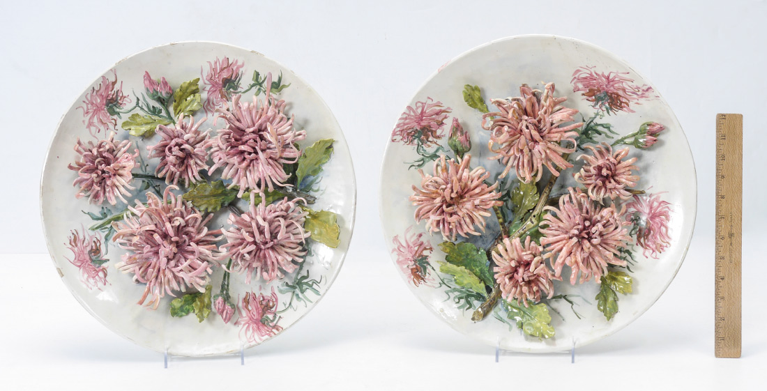 Appraisal: PAIR HIGHLY DETAILED FAIENCE CHARGERS Chrysanthemums appear to be growing