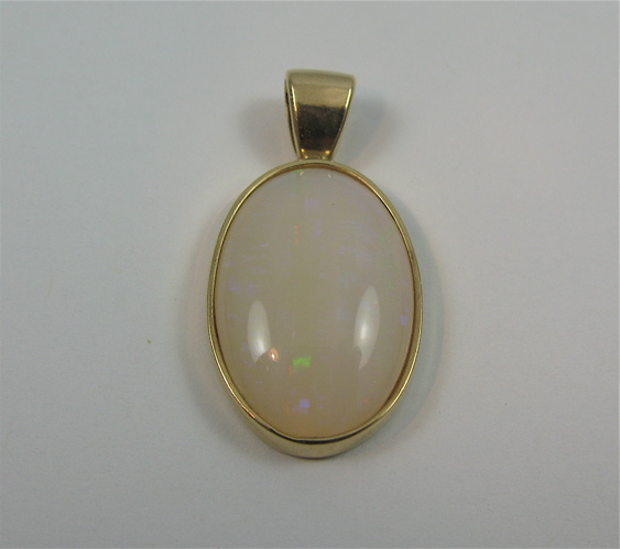 Appraisal: OPAL AND K GOLD PENDANT set with an oval opal