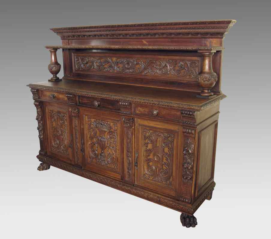 Appraisal: ELABORATELY CARVED EDWARDIAN SIDEBOARD Full length shelf supported by urn