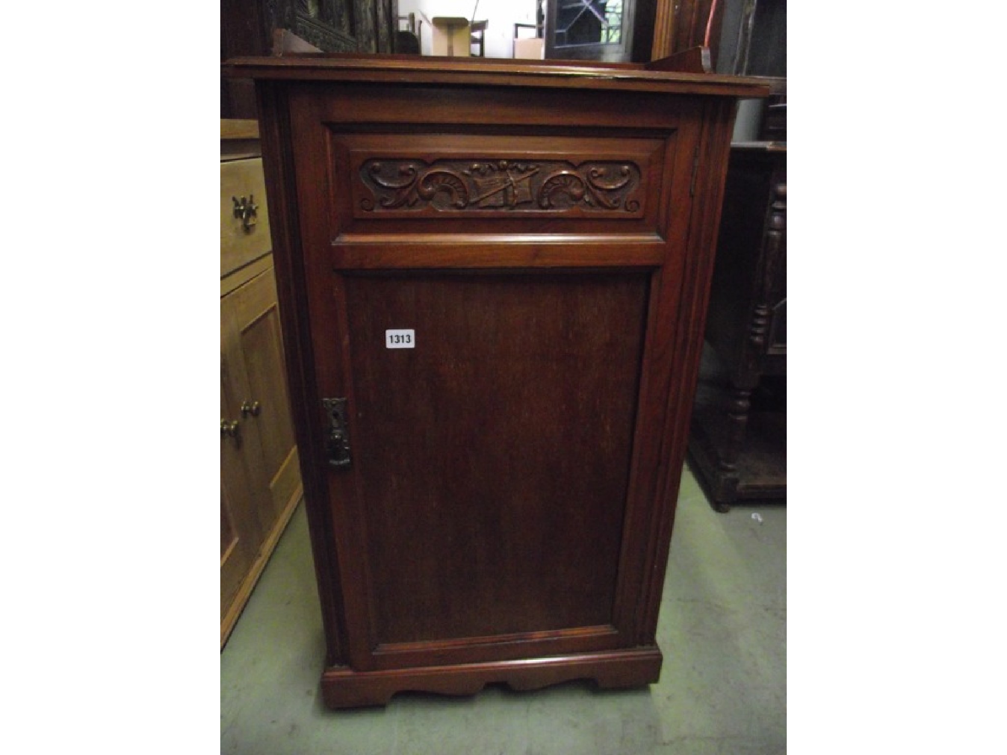 Appraisal: An Edwardian walnut music cabinet with shallow three quarter gallery