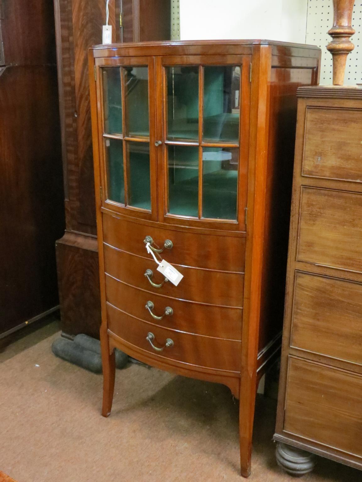 Appraisal: An early th century bow-fronted mahogany music cabinet pair of