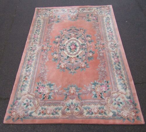 Appraisal: A Chinese wool cut rug on a pink floral ground