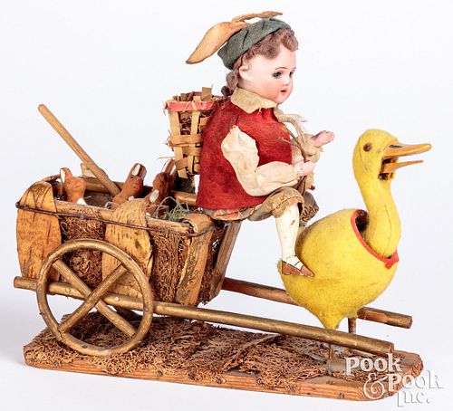 Appraisal: BISQUE HEAD DOLL RIDING A DUCK CARTBisque head doll riding