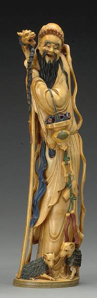 Appraisal: A carved and tinted ivory figure of a sage th