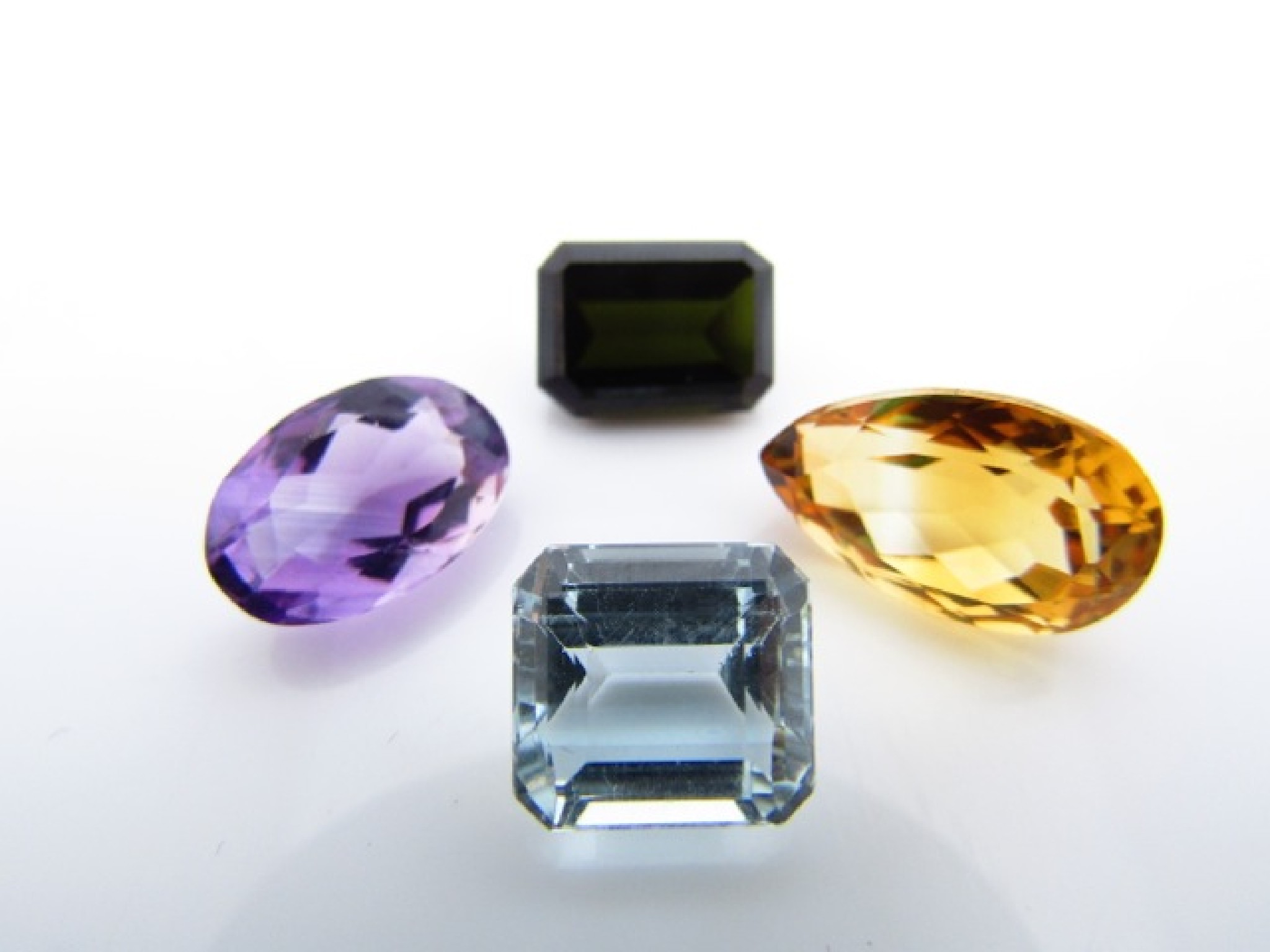 Appraisal: A collection of four unmounted gemstones untested comprising a pear-shaped