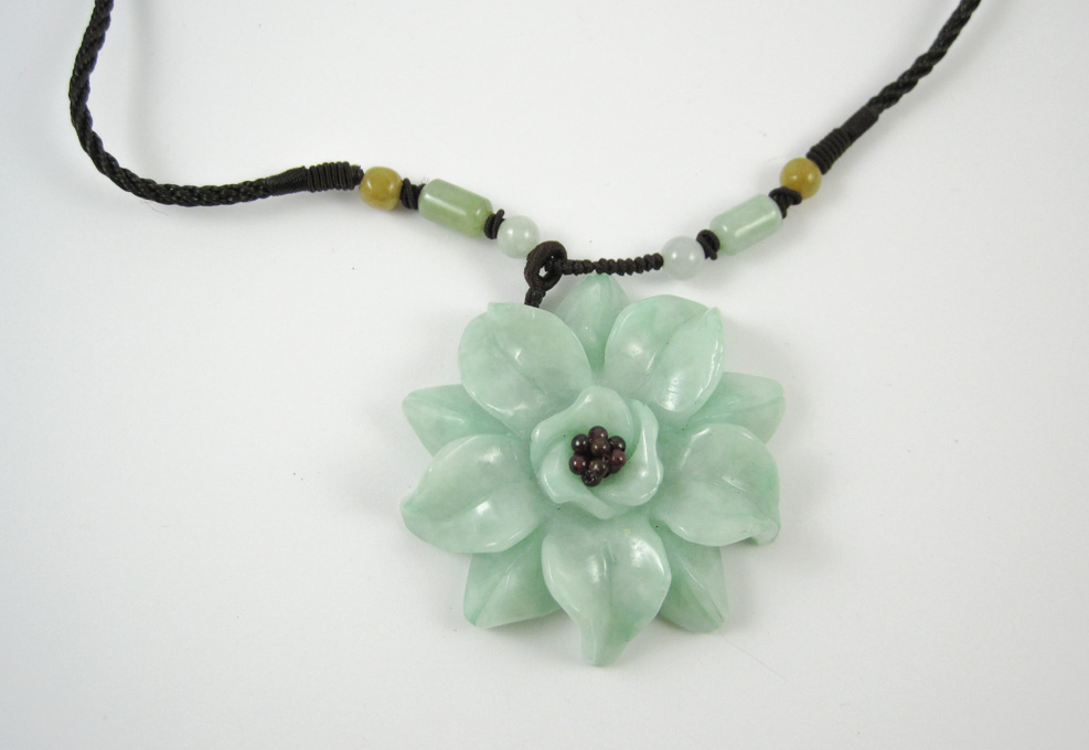 Appraisal: GREEN JADE AND GARNET NECKLACE secured to an adjustable dark