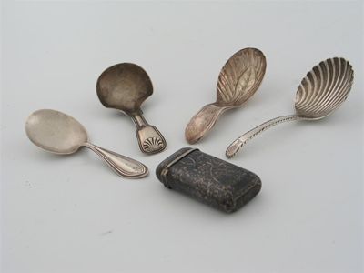 Appraisal: Four caddy spoons and a vesta case a George III