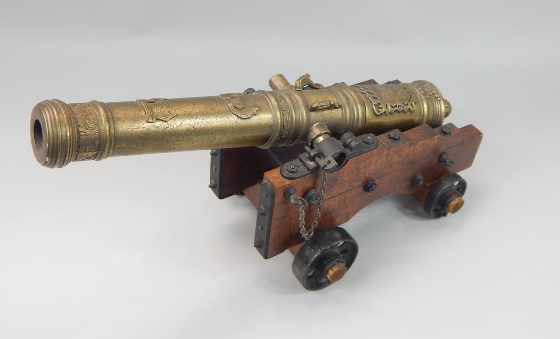 Appraisal: A brass finish table cannon of medieval style on a