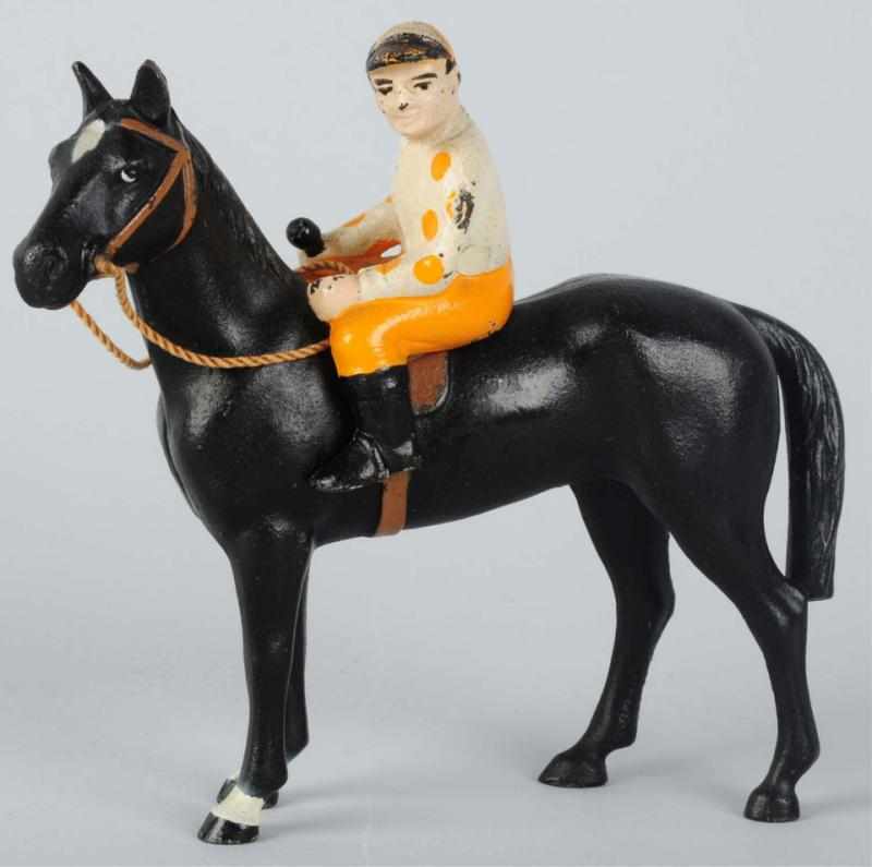 Appraisal: Cast Iron Horse Jockey Paperweight Hubley Full-figure black horse Jockey