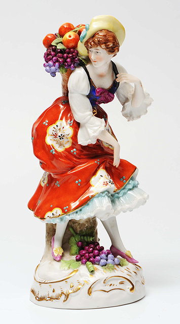 Appraisal: A CONTINENTAL PORCELAIN FIGURE of a girl with polychrome costume