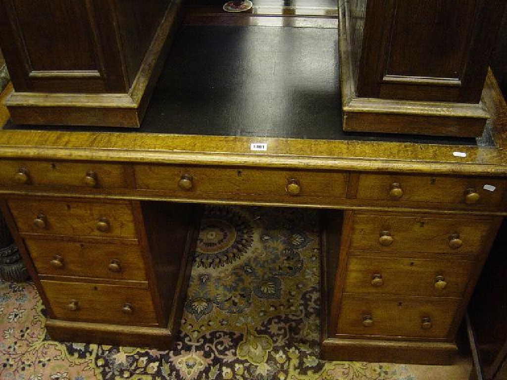 Appraisal: A Victorian oak kneehole pedestal desk with inset leather top