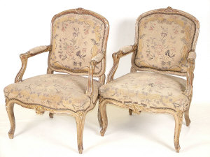 Appraisal: A pair of Louis XV style giltwood open armchairs mid