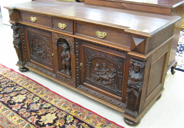 Appraisal: CARVED OAK SIDEBOARD Continental th century having three aligned drawers