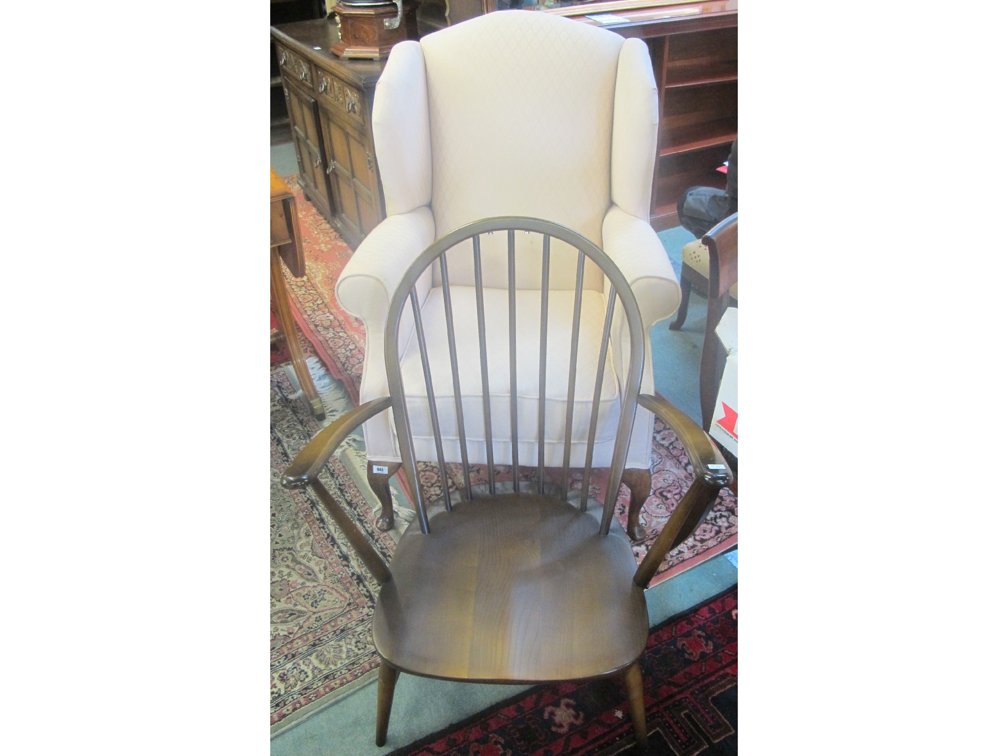 Appraisal: A wingback armchair and an Ercol chair