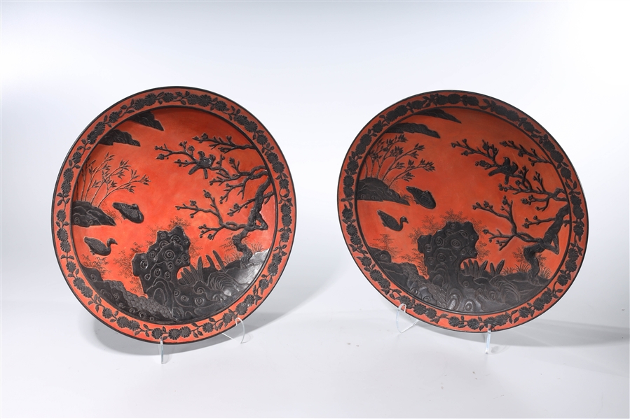 Appraisal: Two Chinese red ground porcelain chargers with black relief design