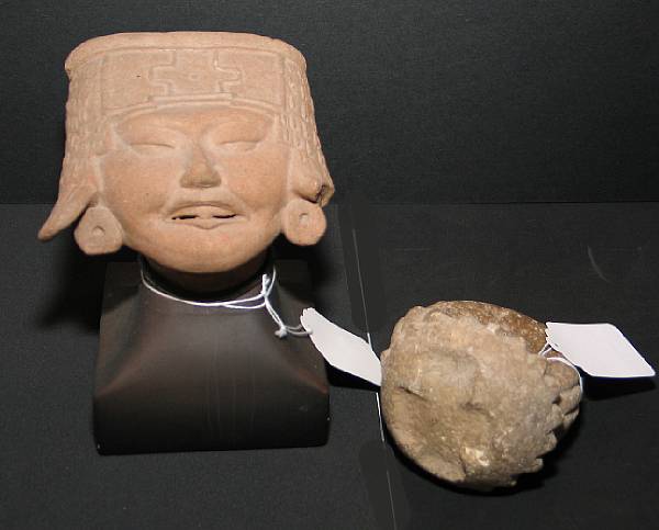 Appraisal: Two pre-Columbian items A Veracruz smiling face head fragment circa