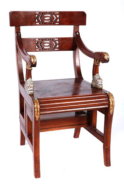 Appraisal: A metamorphic mahogany library armchair height in width in depth