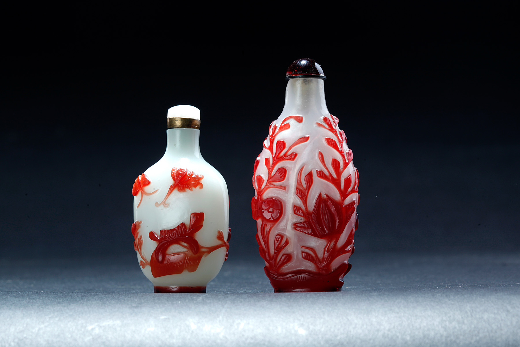 Appraisal: TWO CHINESE PEKING GLASS SNUFF BOTTLES Nineteenth century Red flowers