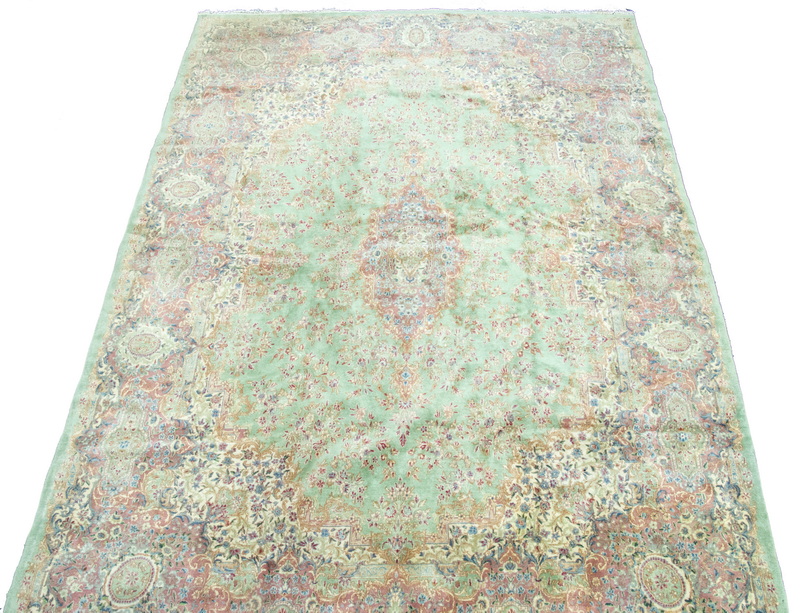 Appraisal: KERMAN CARPET An elongated gabled floral medallion with matching pendants