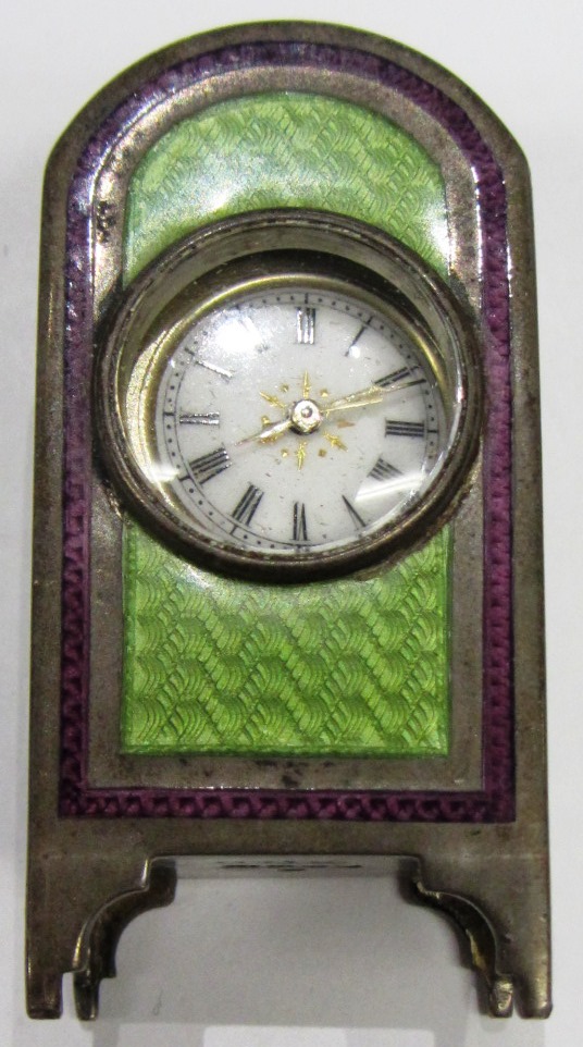 Appraisal: A silver cased green and mauve enameled miniature clock with