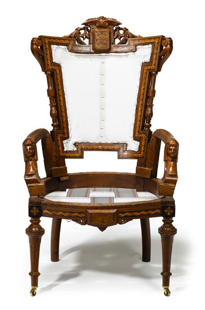 Appraisal: Egyptian Revival carved and inlaid rosewood armchairprobably john jeliff newark