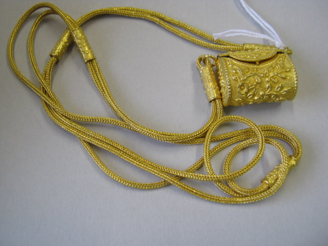 Appraisal: A gold pendant designed as a hinge lidded bag decorated