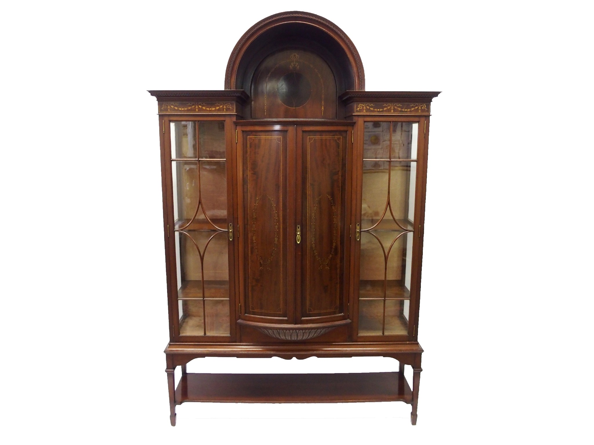 Appraisal: An Edwardian mahogany inlaid display cabinet on standthe arched top