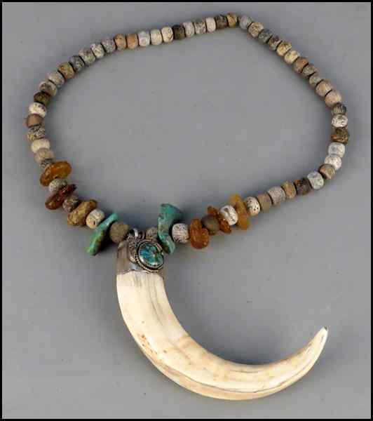 Appraisal: CARVED BONE TRIBAL NECKLACE With carved masks and clay beads