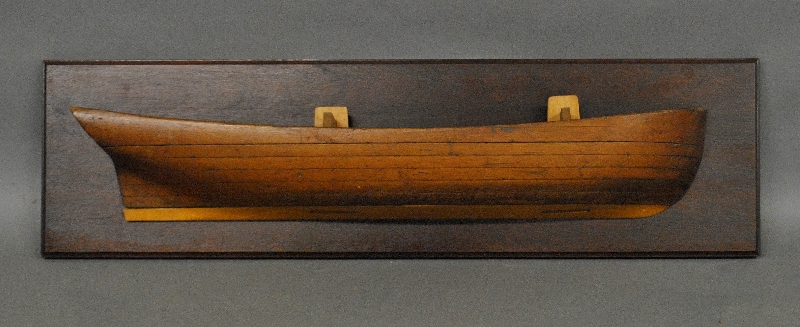 Appraisal: - Laminated pine half-hull model mounted on a mahogany backboard