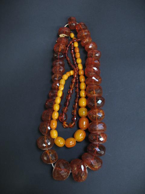 Appraisal: A STRING OF LARGE GRADUATED AMBER BEADS and two other