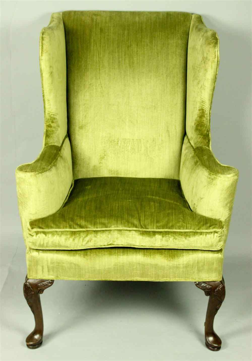 Appraisal: QUEEN ANNE STYLE GREEN UPHOLSTERED WING CHAIR having a staight