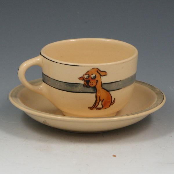 Appraisal: Roseville Juvenile glossy puppy cup and saucer Unmarked Wear to