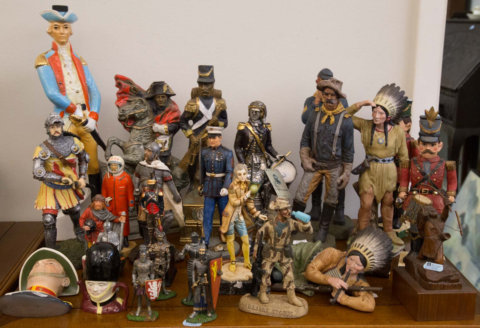 Appraisal: Assortment of figurines including metal wood porcelain composition mostly military