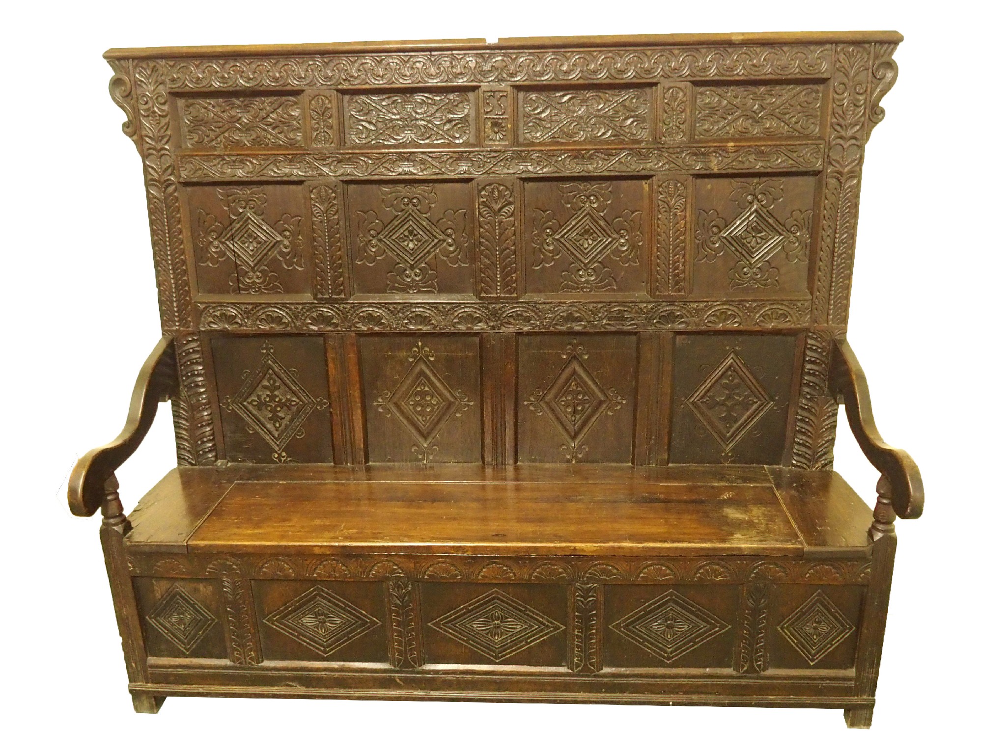 Appraisal: An oak settlethe carved four panel back with SS initials