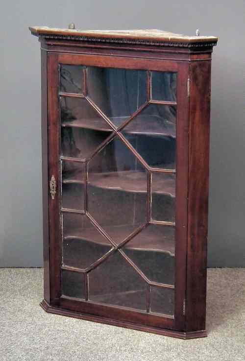 Appraisal: An th Century mahogany hanging corner cupboard with moulded and