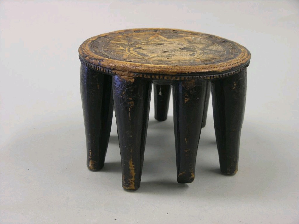 Appraisal: An Ashanti stool the top incised with diagonal devices on