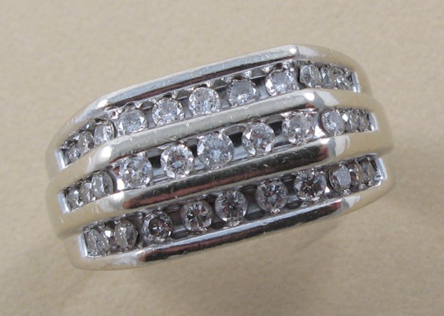 Appraisal: MAN'S DIAMOND AND FOURTEEN KARAT GOLD RING set with round-cut