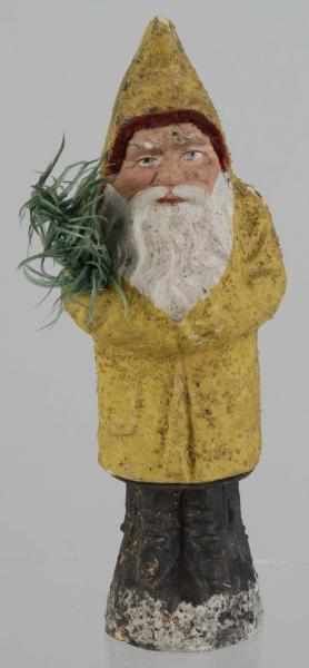 Appraisal: Yellow Belsnickel Santa Candy Container Description Folded arms holding fir