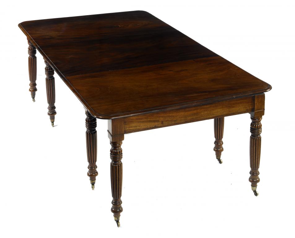 Appraisal: A GEORGE IV MAHOGANY EXTENDING DINING TABLE on eight reeded