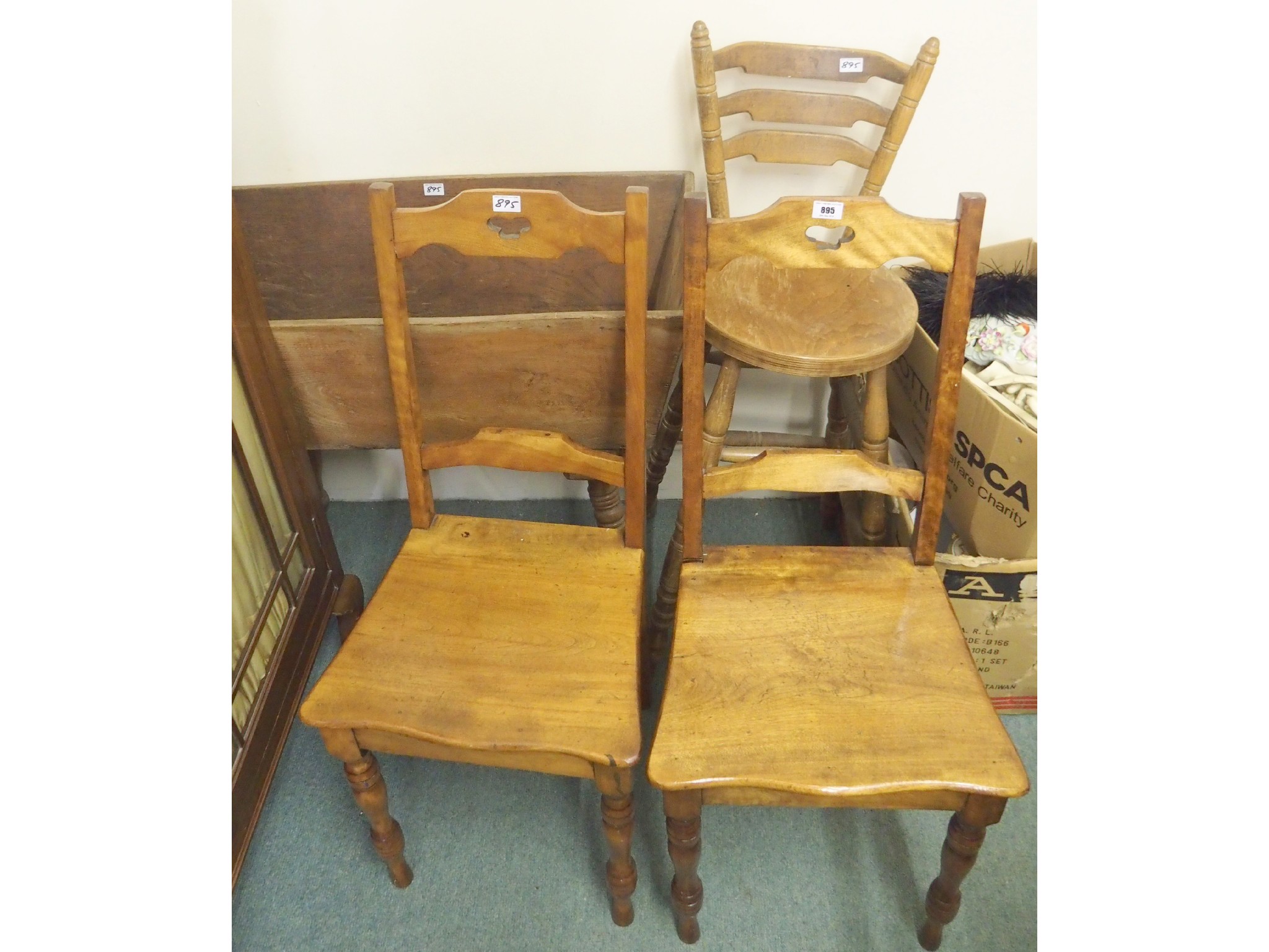 Appraisal: A wooden crib pair of hall chairs and a ladderback