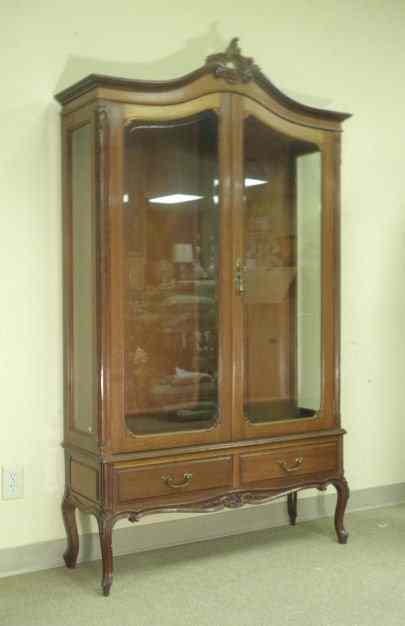 Appraisal: Carved wood French style display cabinet with a brownish mahogany