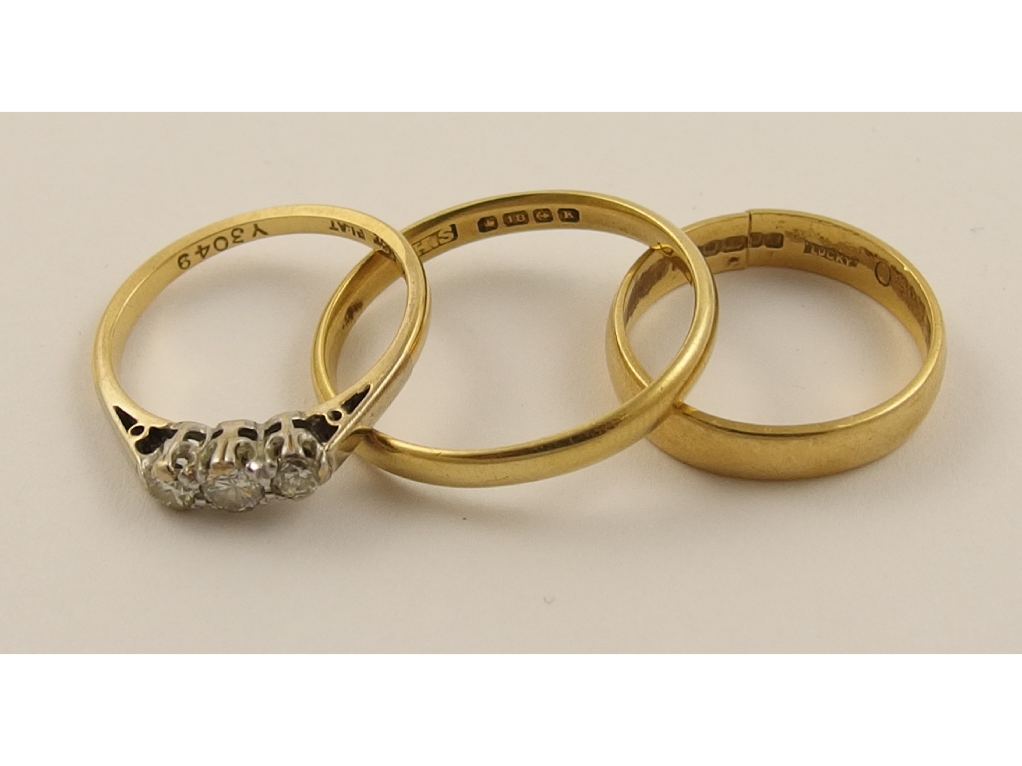 Appraisal: Two ct wedding bands and an ct three stone diamond